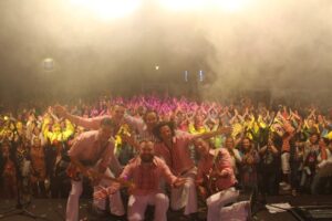 Musikband posiert vor Publikum auf Bühne